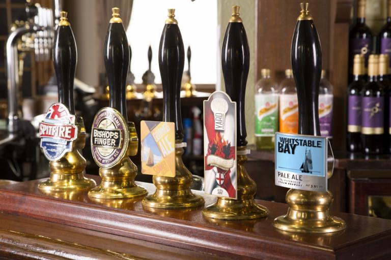 An image of mixed pump clips from Shepherd Neame on the bar